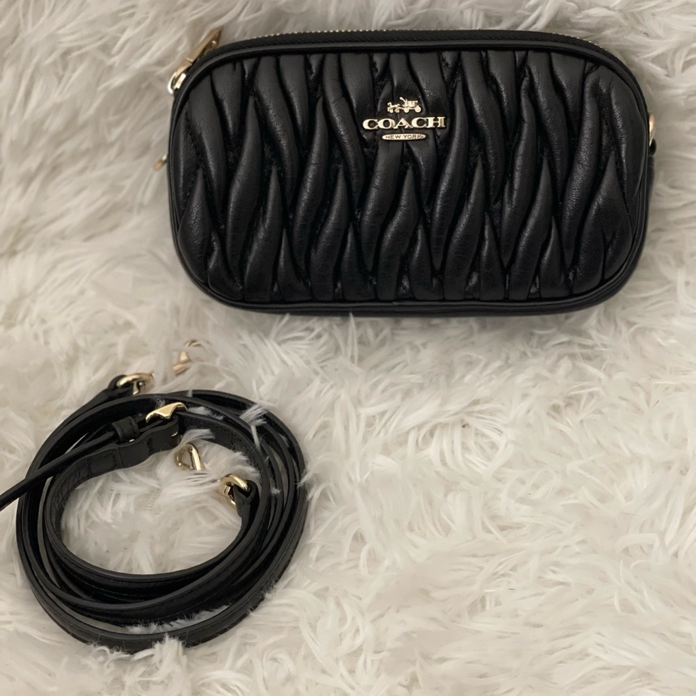 Black Coach quilted crossbody purse with 2 compartments.